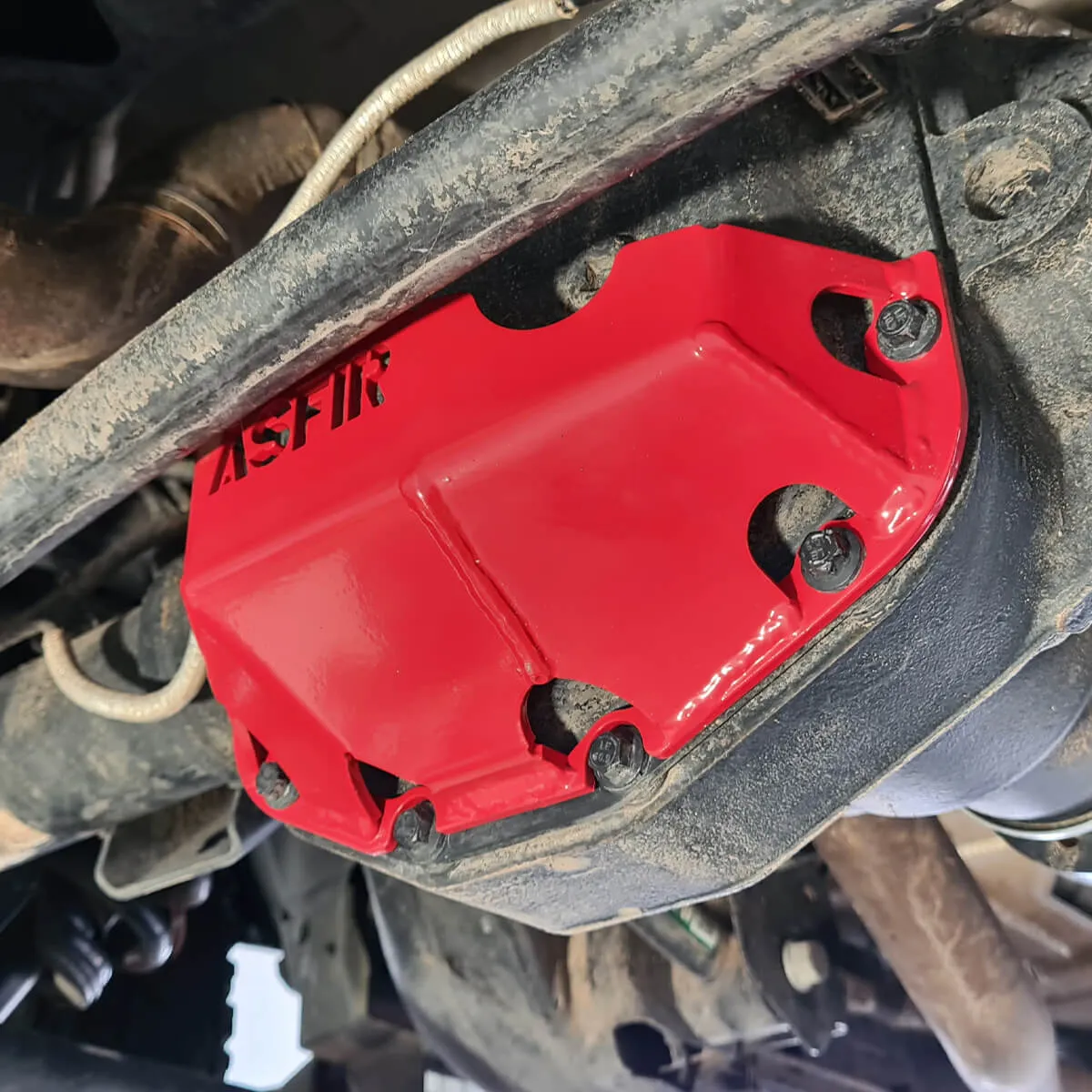 Red ASFIR differential skid plate installed on a 4Runner axle